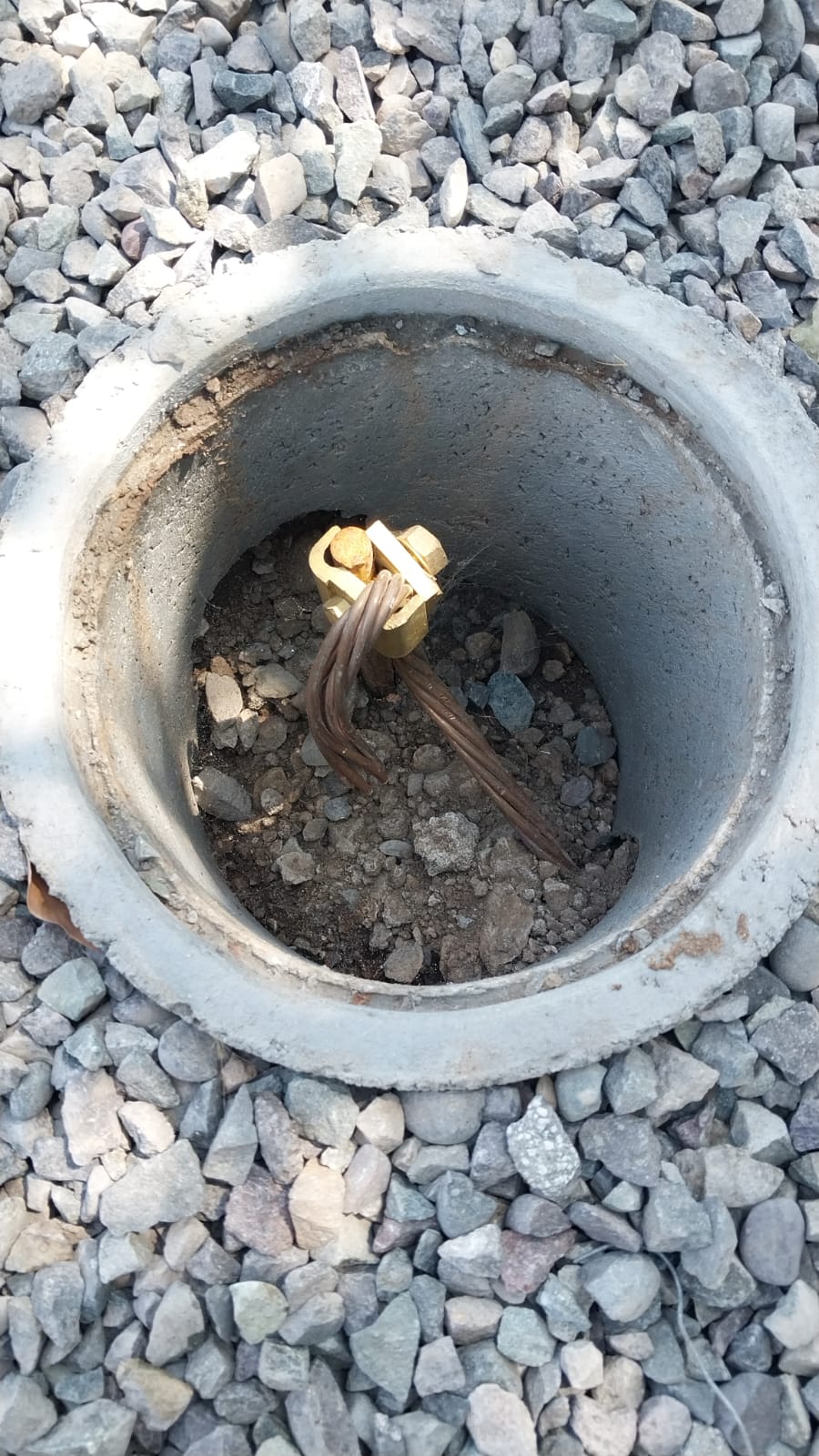 Cámara de registro con el conector y cable de cobre de una puesta a tierra instalada